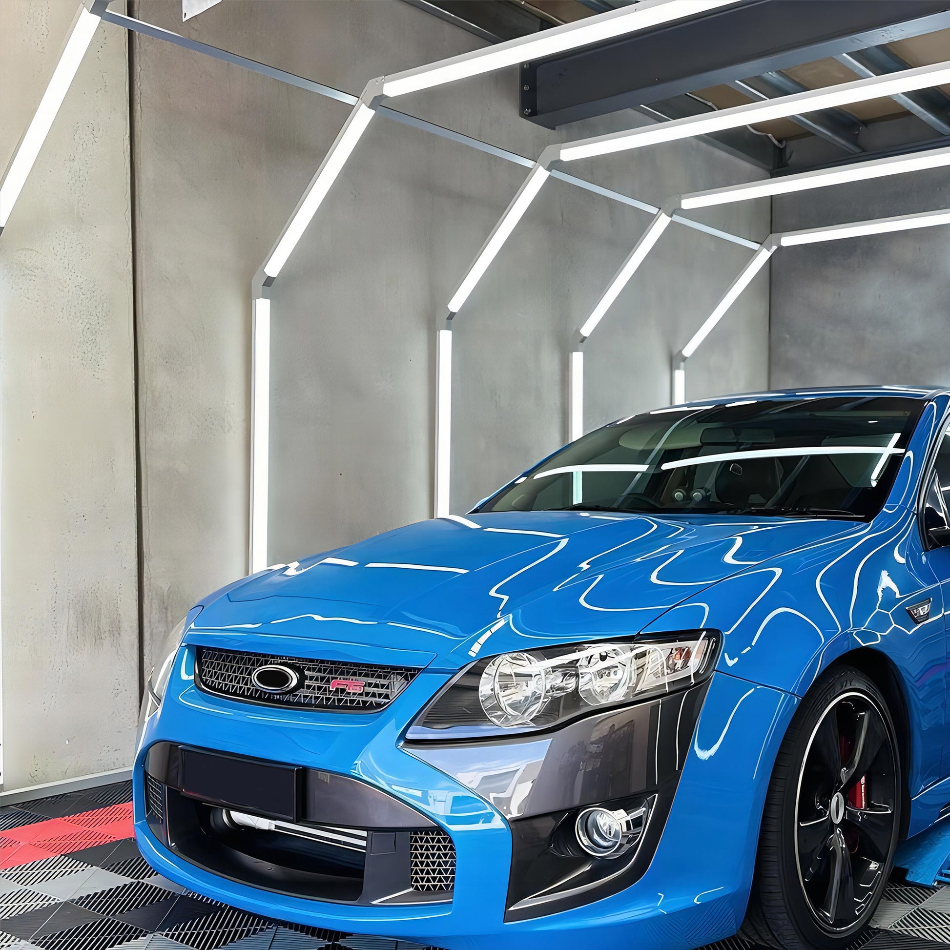 Multiple Portaleon SGE1011 Hexagon LED Tunnel Lights creating a captivating lighting environment in a modern garage setting.