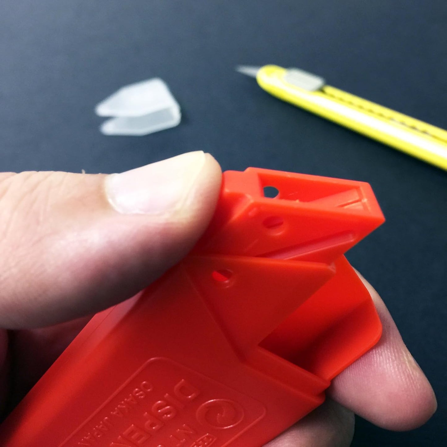 Action shot of NT Cutter 9mm Blade effortlessly cutting through material, demonstrating accuracy.